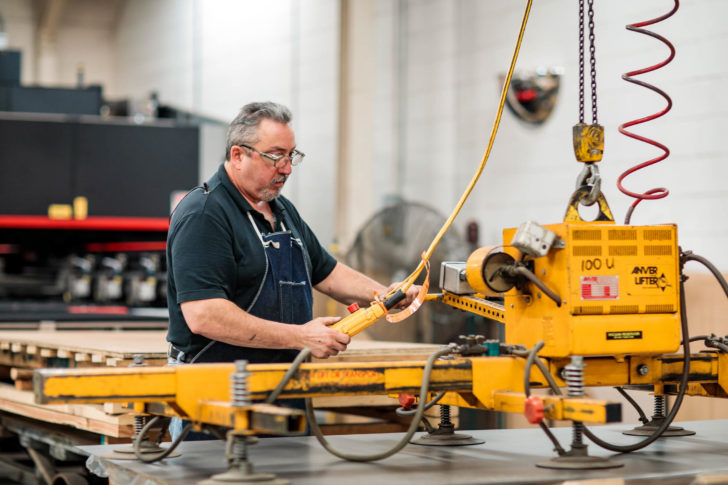 Dawson worker loading sheet metal onto a laser