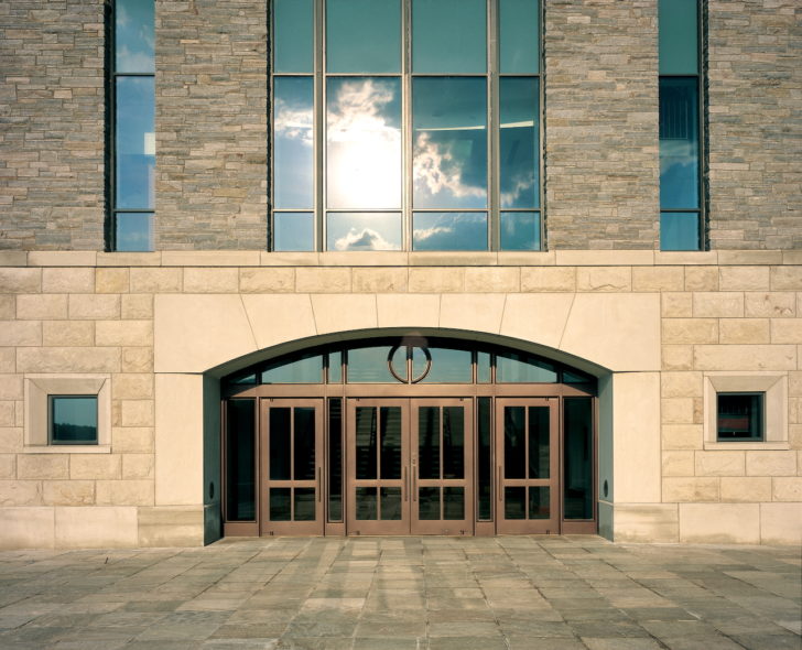 DAWSON Custom Series Balanced doors brass entrance with vaulted custom transom.